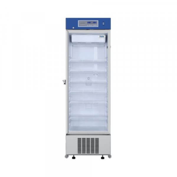 A standard pharmacy refrigerator with a single glass door and multiple adjustable shelves, used for storing medical supplies at controlled temperatures.